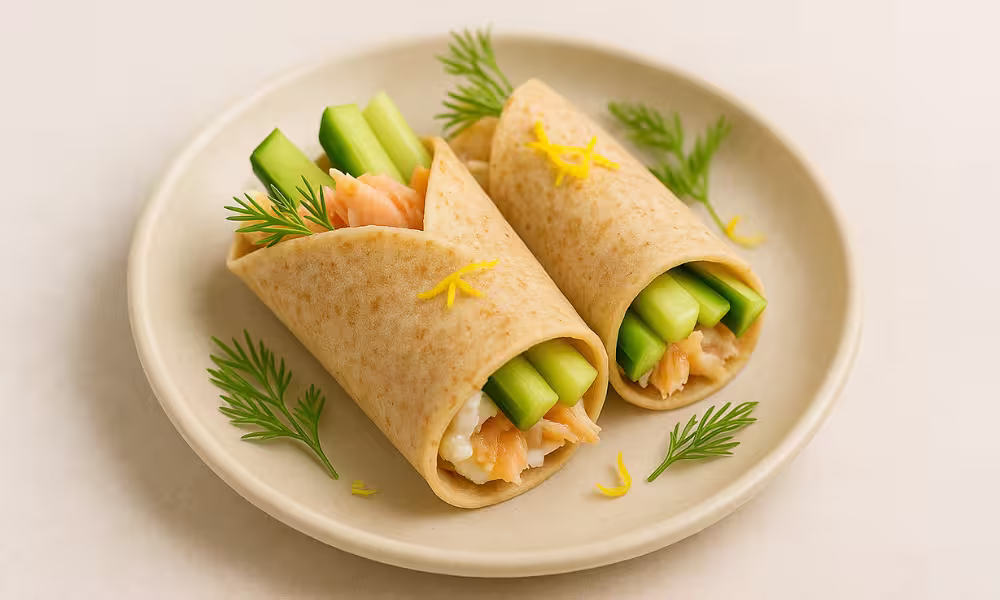 Back-to-school high-protein breakfast wraps with smoked trout, creamy ricotta, cucumber sticks, dill, and lemon zest on a ceramic plate.